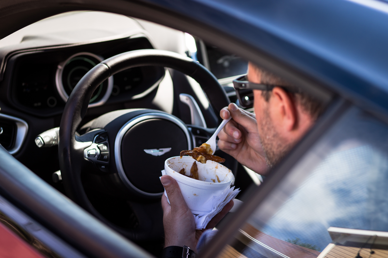 Illustration for article titled Chasing Canada's Greasiest People's Food In A $200,000 Aston Martin